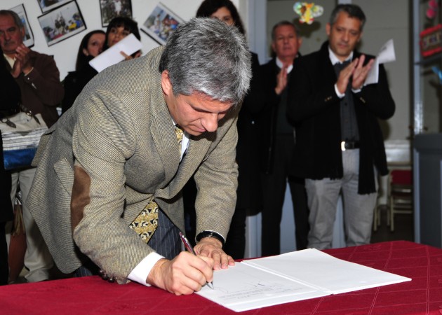 El Gobernador CPN Claudio Poggi firmando los decretos para la construcción de los playones deportivos.