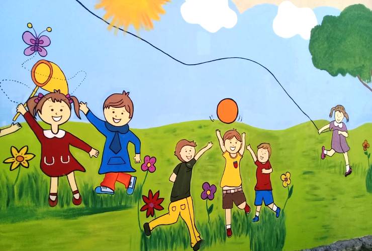 El mural muestra a unos niños felices en un espacio verde y natural.